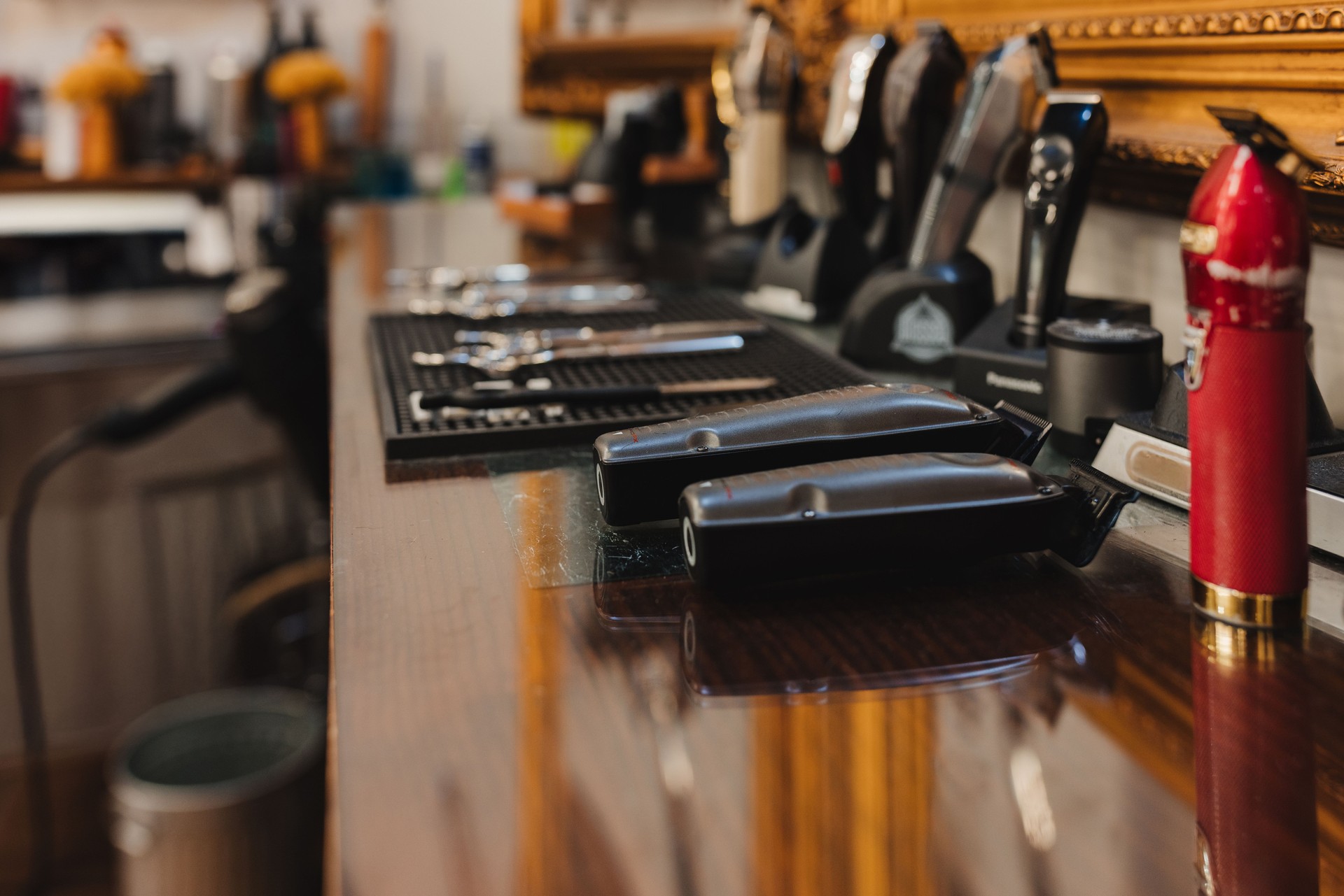 A barber shop with a red bottle of hair spray on the counter